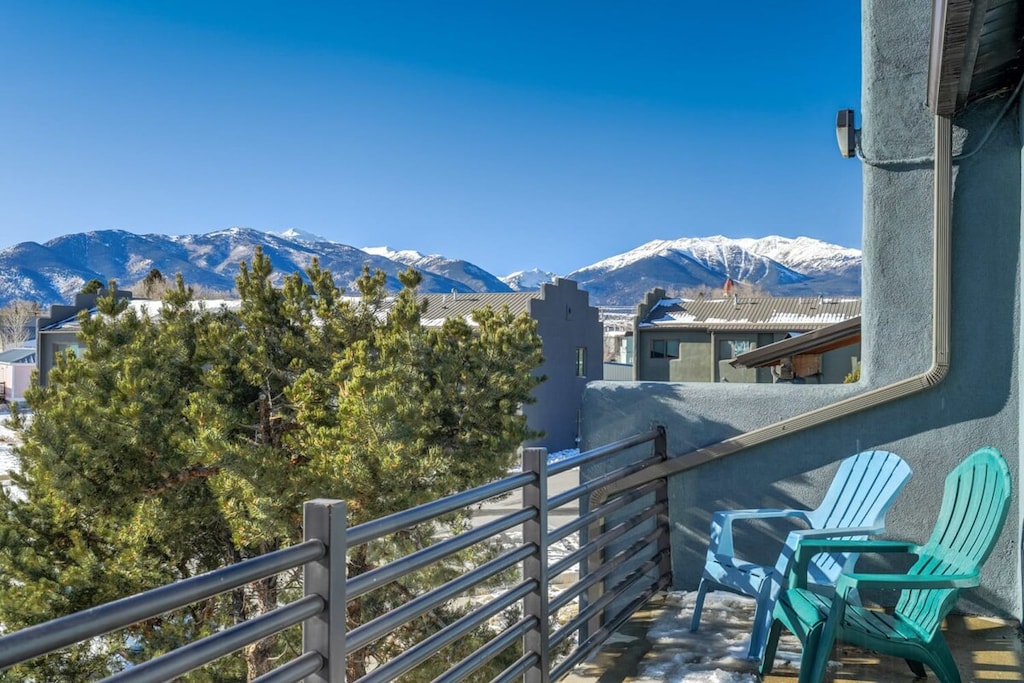The second-story patio boasts comfy chairs, offering a perfect spot to unwind. Enjoy a picturesque view of Mt. Princeton, creating a serene and relaxing outdoor retreat.