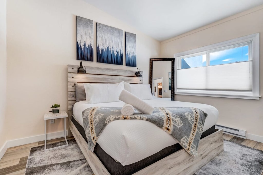The master bedroom features a luxurious king-sized bed and a smart TV, creating a comfortable retreat for relaxation. Enjoy the perfect blend of comfort and entertainment in this well-appointed space.