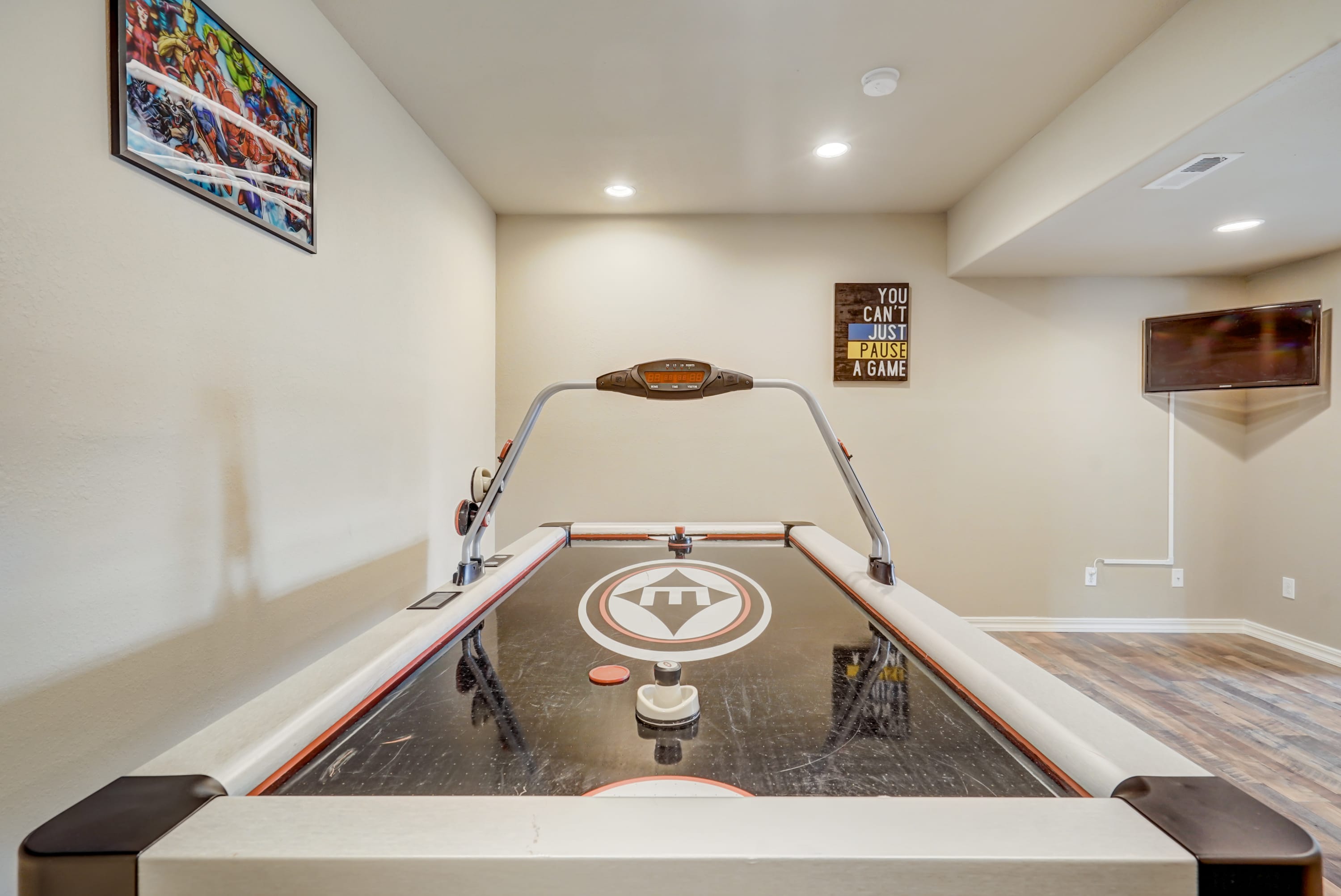 Bring out the competitive spirit of everybody in an air hockey match in this game room.