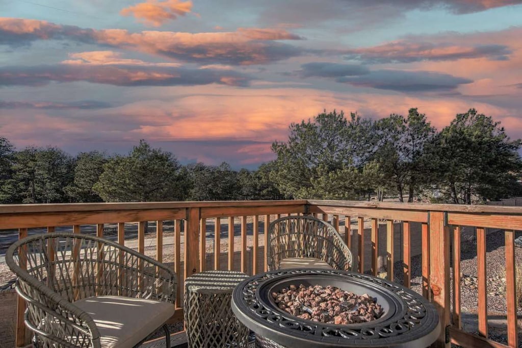 private deck where tranquility meets warmth. Imagine evenings spent gathered around the crackling fire pit, the stars above, and the soothing ambiance surrounding you. Plush chairs offer comfort and conversation, creating the perfect setting