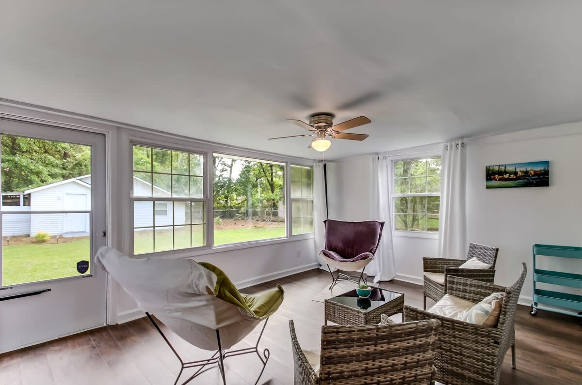 Large sunroom with view of backyard.