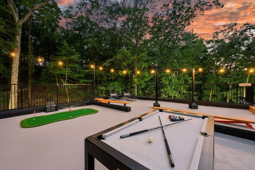 3rd floor outdoor deck includes pool table, putt putt, corn hole, and outdoor seating