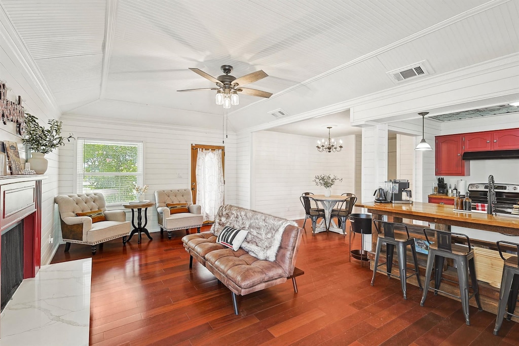 Howdy! This cheerful living room is sure to bring a smile to your face with its playful red fireplace, bright shiplap walls, and open-concept layout.