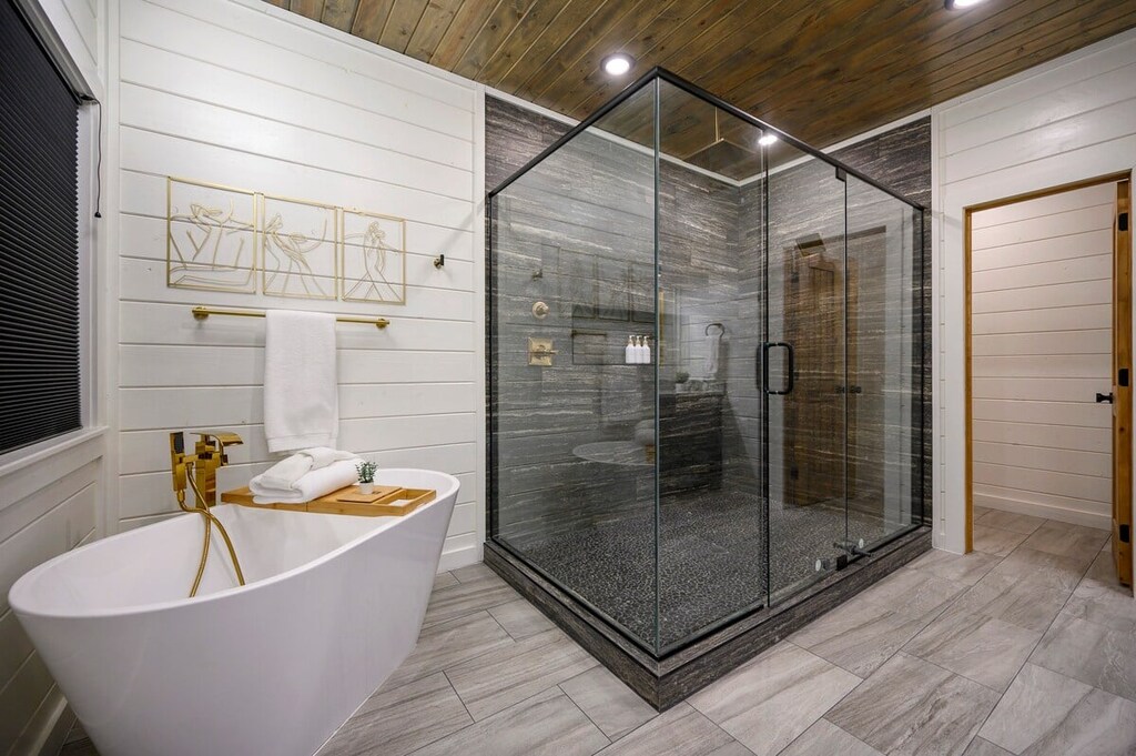 Downstairs master bathroom features a double vanity, soaker tub, and spacious walk-in shower