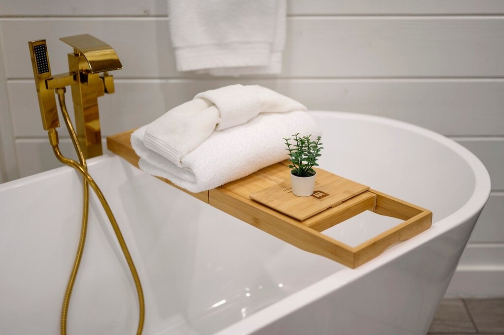 Downstairs master bathroom features a double vanity, soaker tub, and spacious walk-in shower