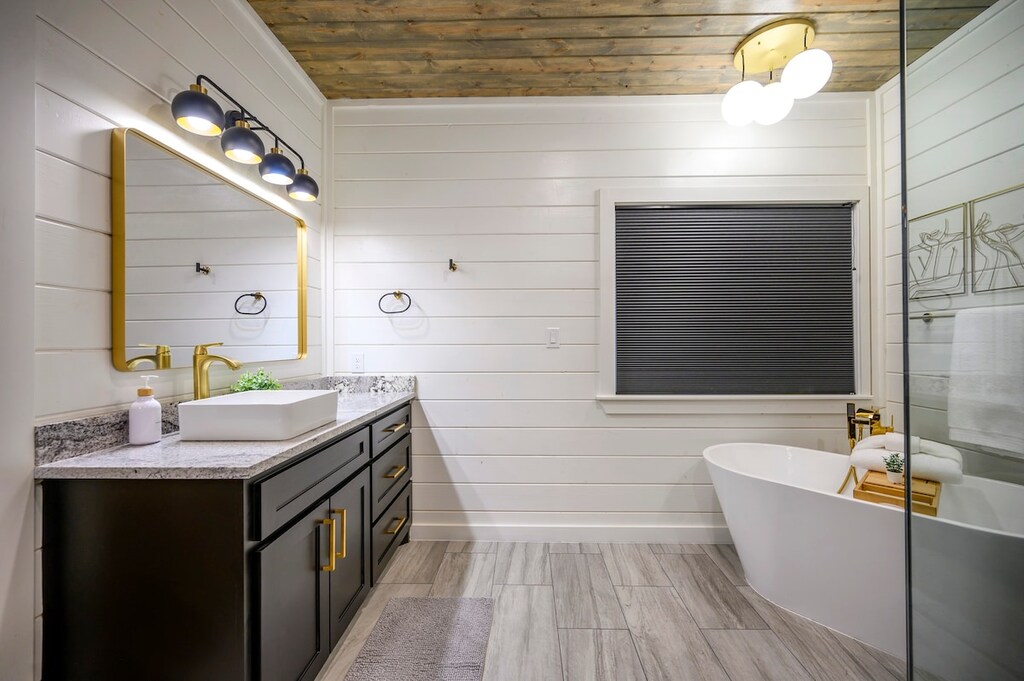 Downstairs master bathroom features a double vanity, soaker tub, and spacious walk-in shower