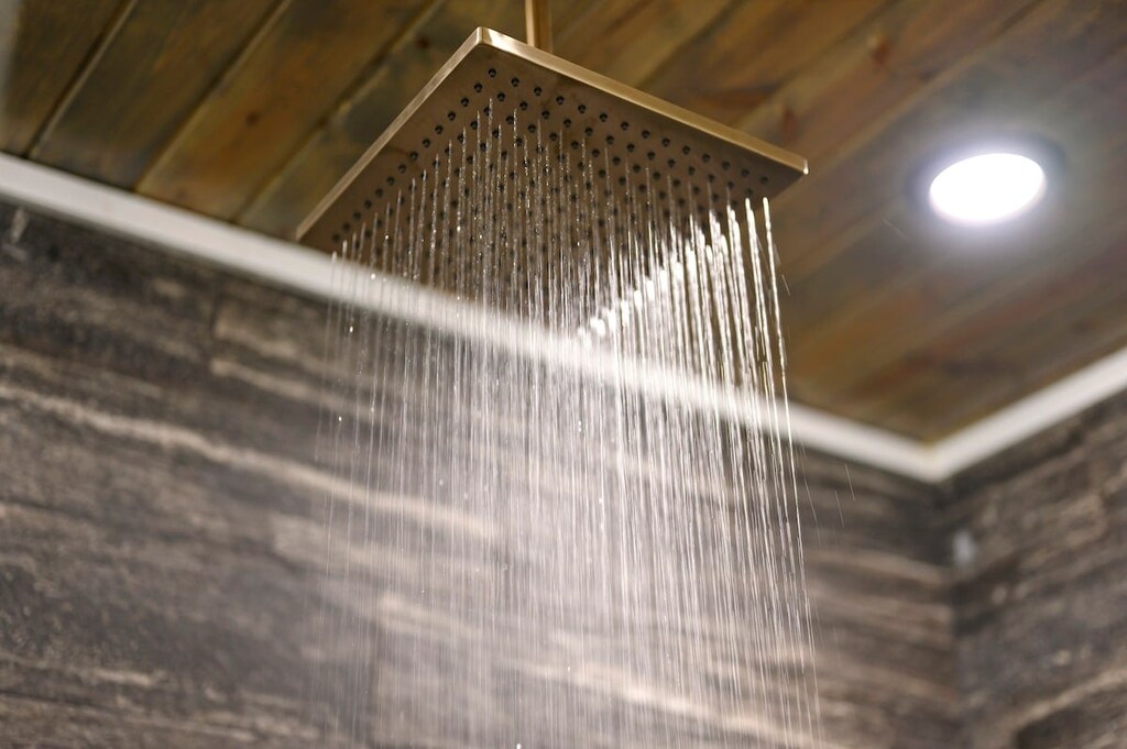 Downstairs master bathroom features a double vanity, soaker tub, and spacious walk-in shower