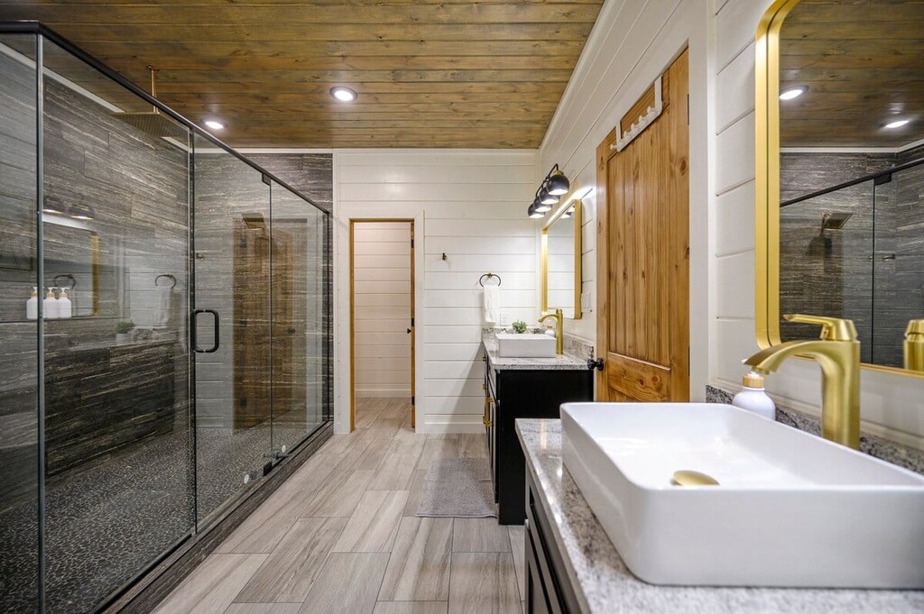 Downstairs master bathroom features a double vanity, soaker tub, and spacious walk-in shower