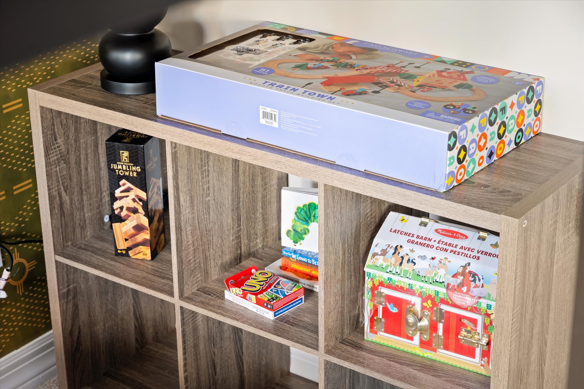 Explore the fun and learning corner of the bedroom, stocked with educational toys, board games, and card games for hours of engaging play Explore the fun and learning corner of the bedroom, stocked with educational toys, board games, and card games for hours of engaging play