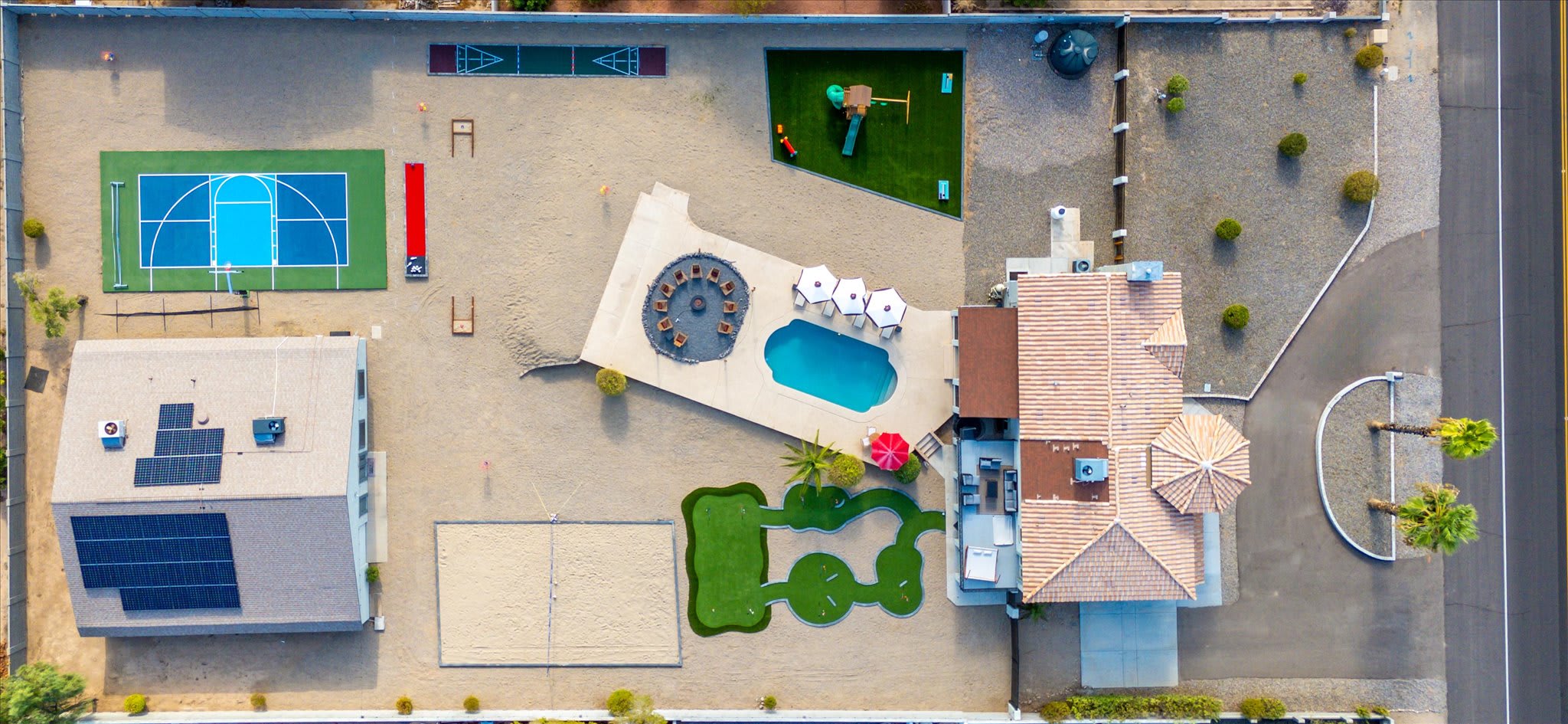 Experience the grandeur of our property from an aerial perspective, showcasing the sprawling yard where every corner is filled with exciting outdoor amenities