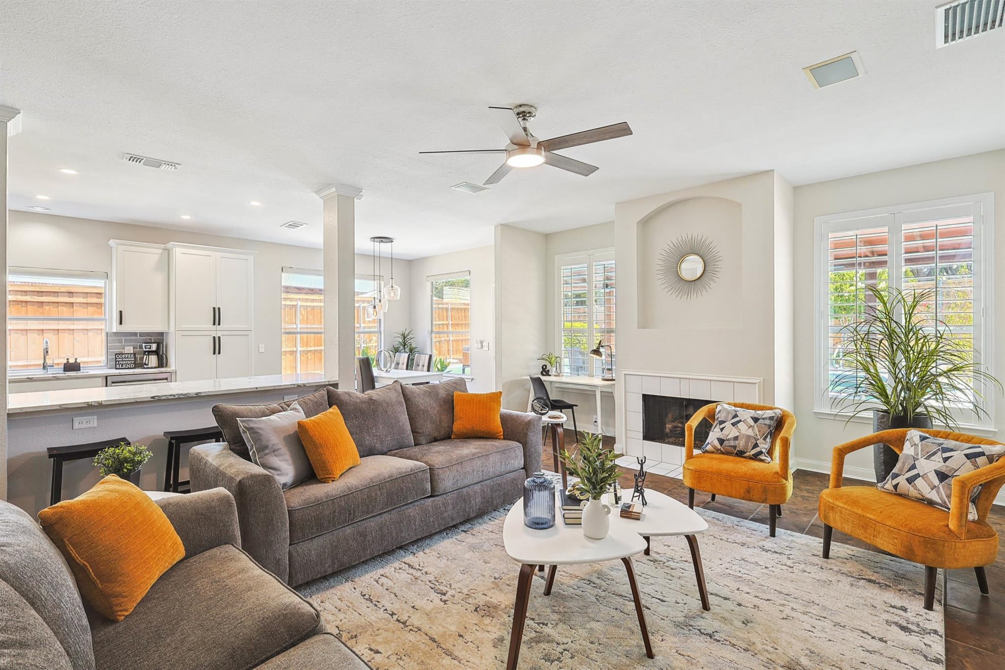 With plenty of comfortable seating as well as stylish pops of color and curated décor, this living room welcomes you to sit back, put your feet up, and simply be yourself!