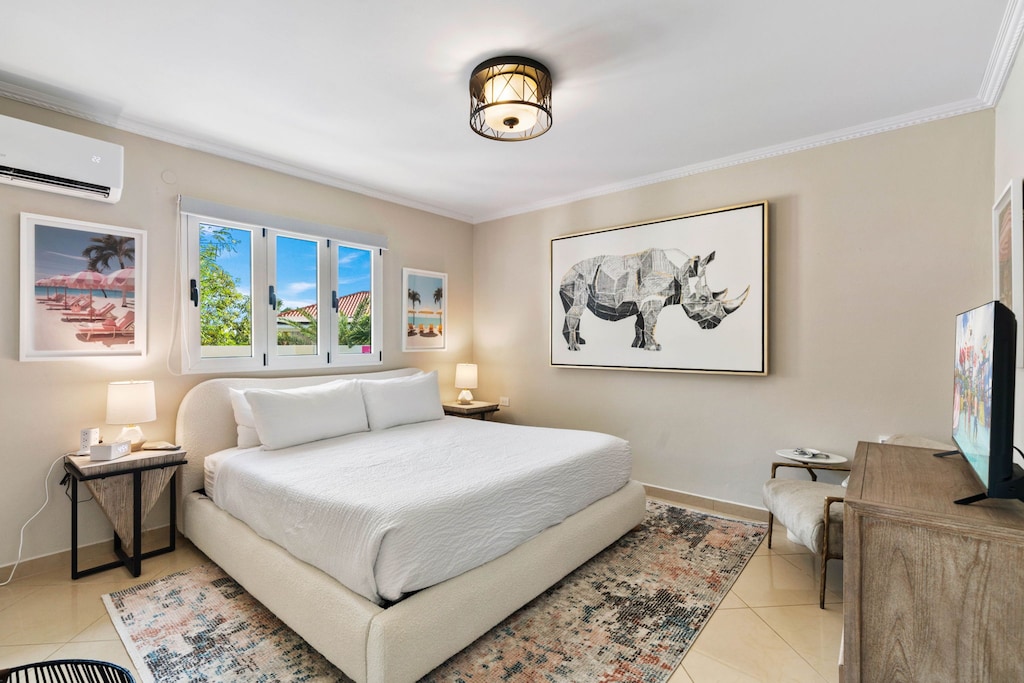 - Tranquil bedroom with a plush king-sized bed and stylish, minimalist decor - Large windows brighten the space, showcasing vibrant wall art and soft, neutral tones - A perfect retreat for restful nights, blending comfort with modern elegance