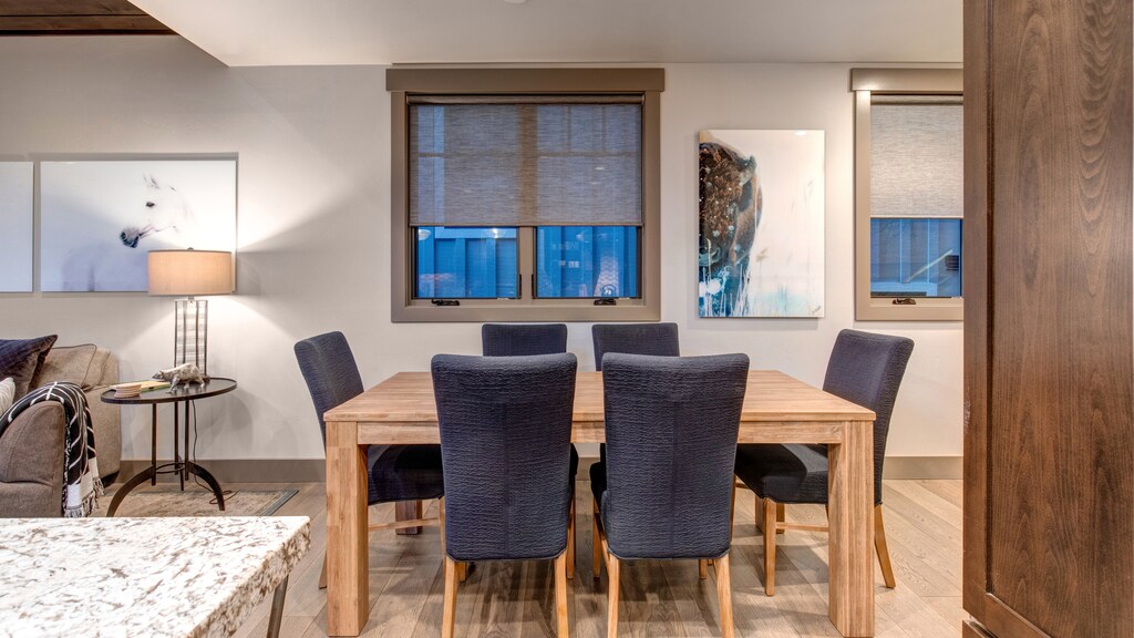 Gather for meals in this stylish dining area with seating for eight, a modern wood table, and charming decor.