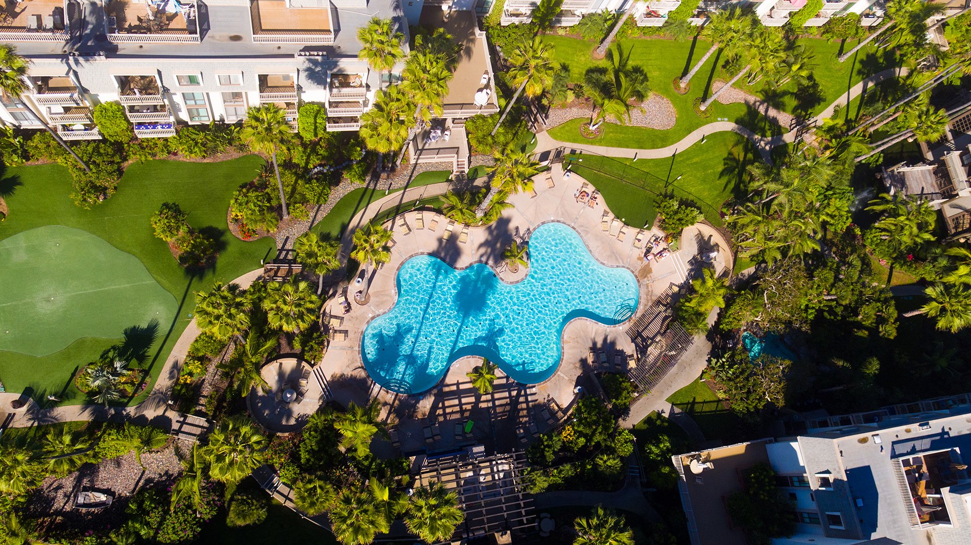  Aerial view of lush tropical grounds and main complex pool