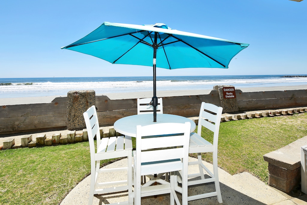 Ground level oceanfront cottage with bar height patio furniture for a perfect beach view