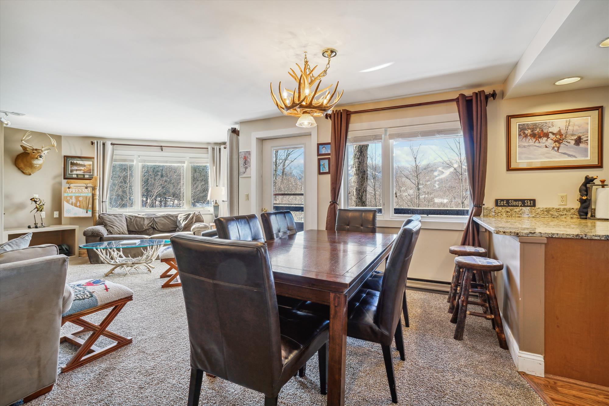 Positioned near large windows, allowing plenty of natural light and offering views of the outdoors.