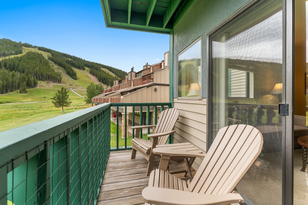 Private balcony with outdoor seating, up-close golf course views in the summer and slope views in the winter. 