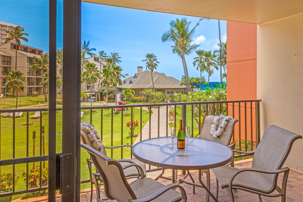 Sip drinks on the lanai at Kaanapali Shores 213 with distant ocean and garden views.