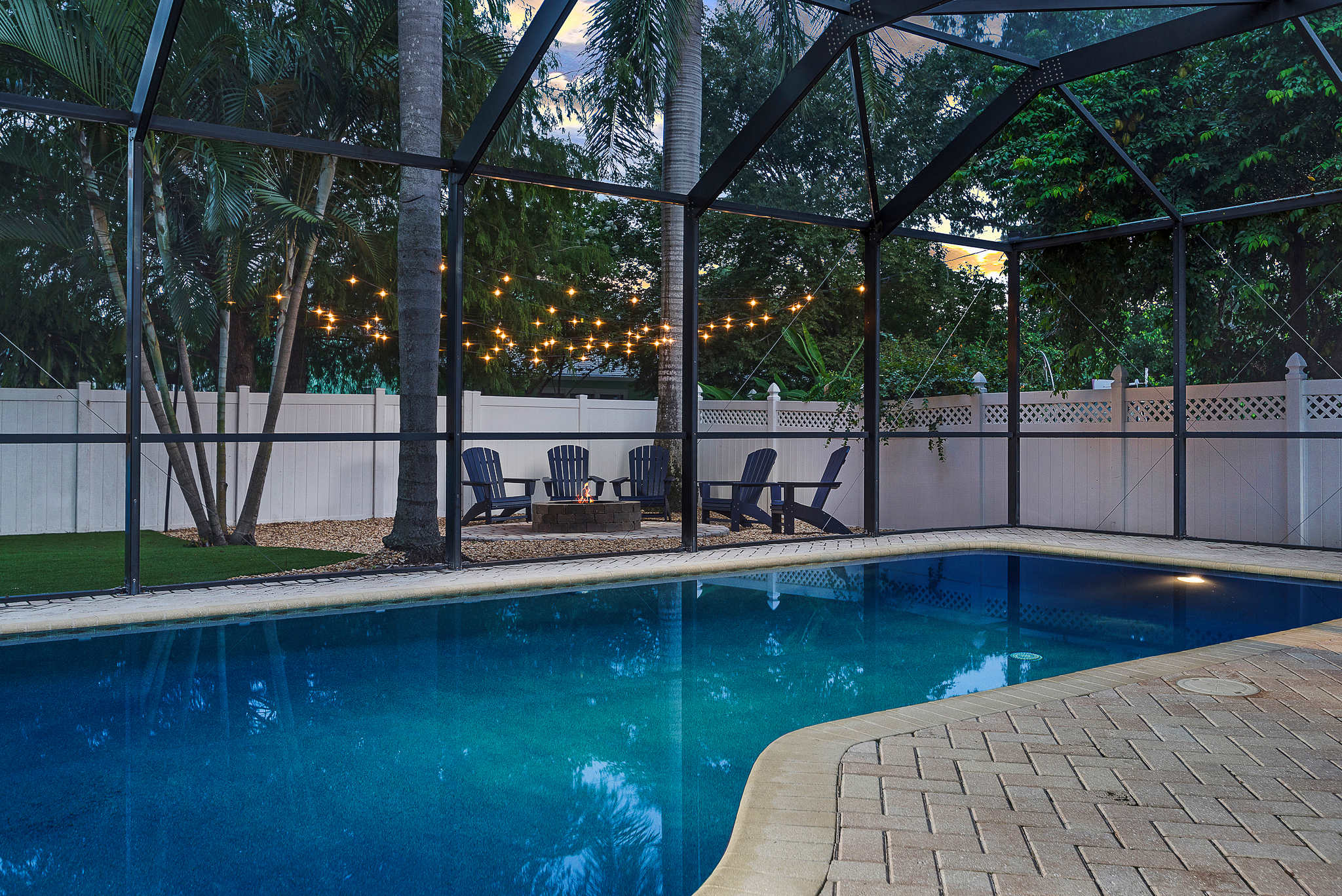 Enjoy a magical evening by the pool, illuminated by string lights and cozy up by the fire pit for a perfect night under the stars