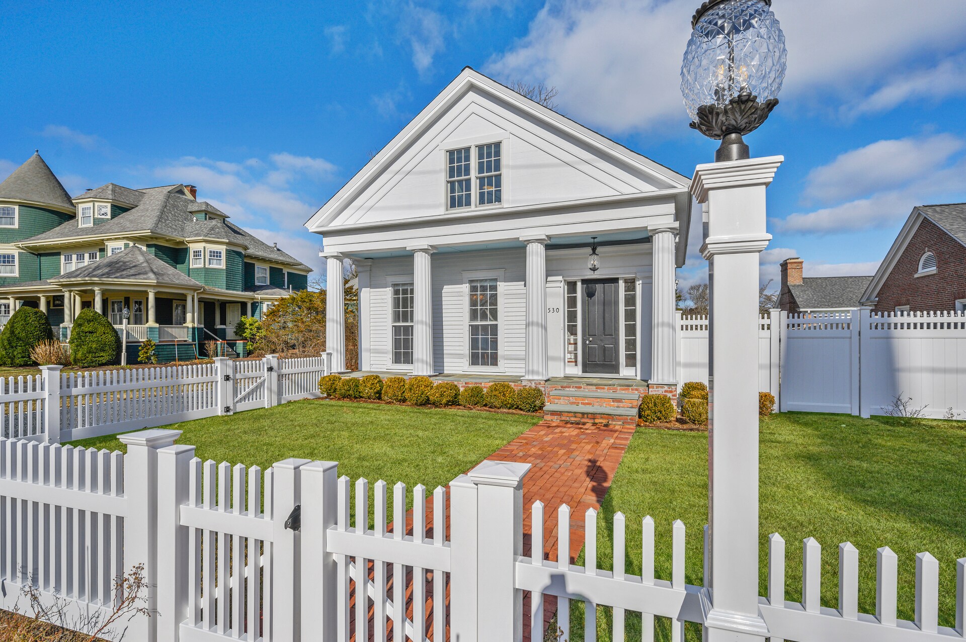 The Pineapple House with fenced in front yard.