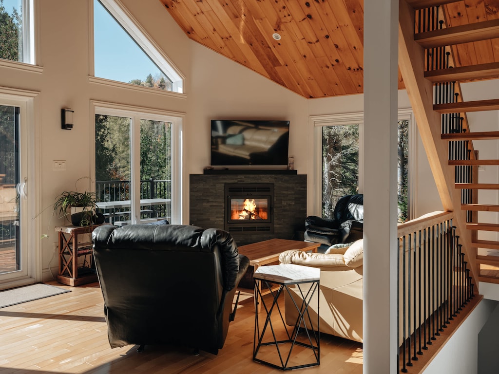 Cozy seating area with fireplace and mezzanine above
