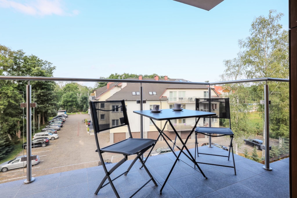 The balcony's stylish design complements the apartment's decor. 