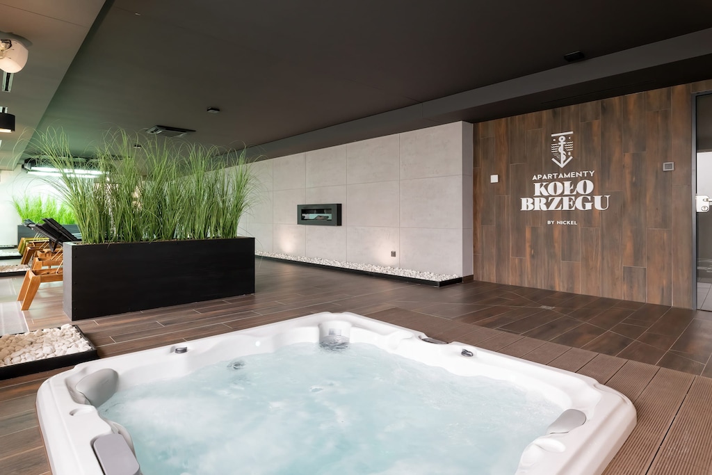 An indoor jacuzzi surrounded by greenery, offering relaxation and luxury.