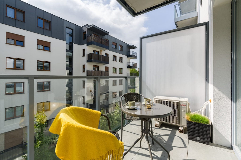 The furnished balcony offers a perfect spot for morning coffee with a view.