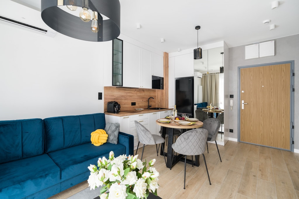 The living area features a sleek coffee table and a flat-screen television.