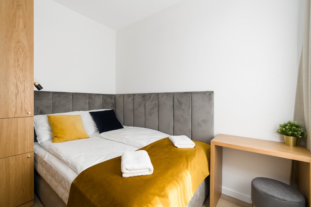 The cosy bedroom features a luxurious double bed and ample storage.