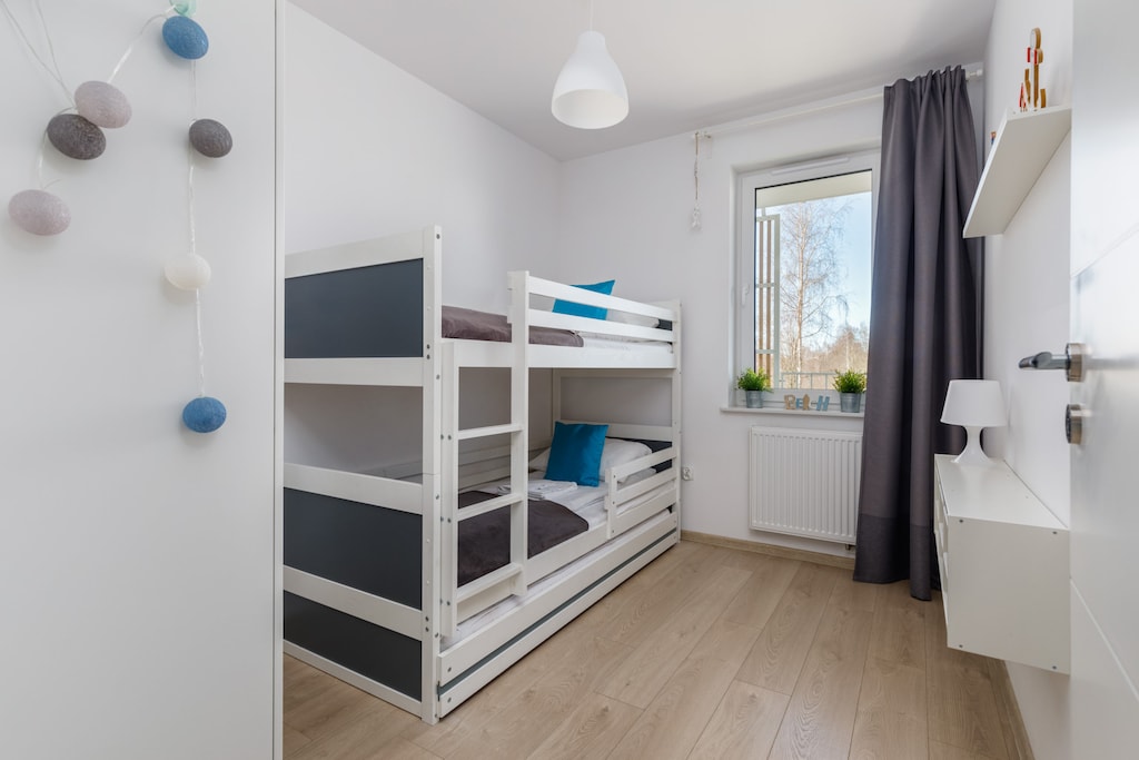 A children's bedroom with bunk beds, bright decor, and a welcoming layout.
