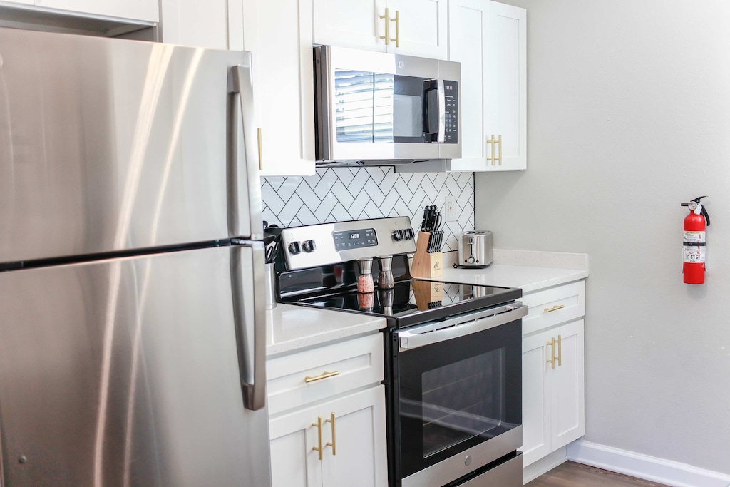 Full kitchen features stainless steel designed appliances.