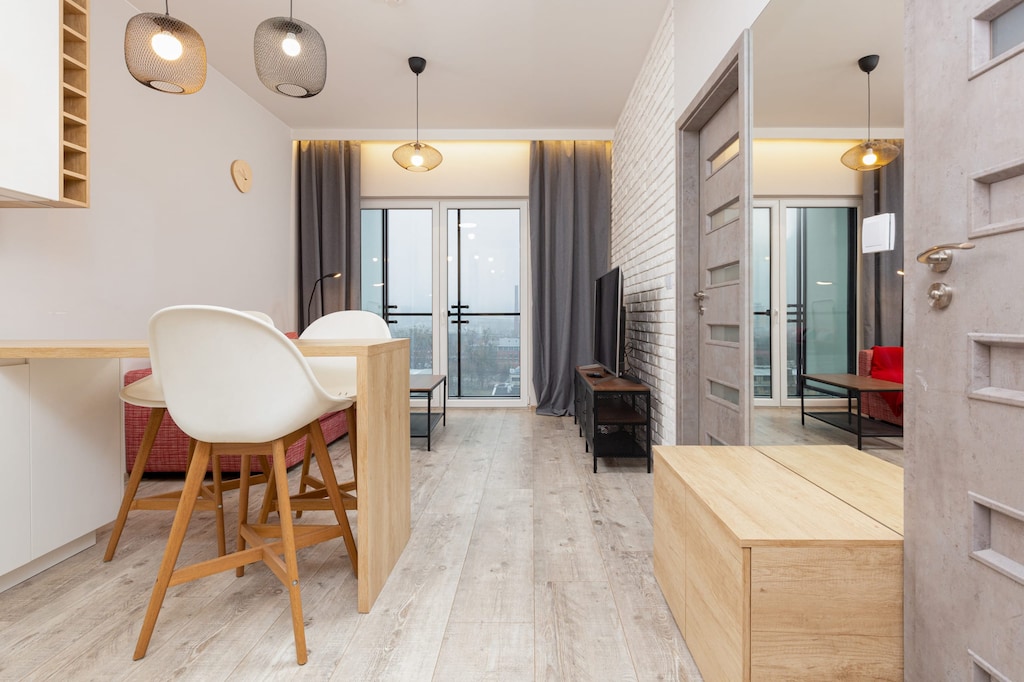 A chic dining setup with wooden furniture, contemporary lighting, and an open layout for seamless dining experiences.