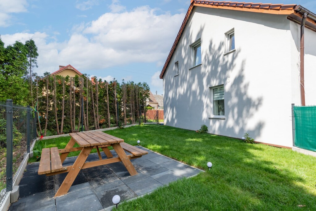 Another view of the outdoor area, showcasing additional picnic spaces surrounded by a serene environment.

