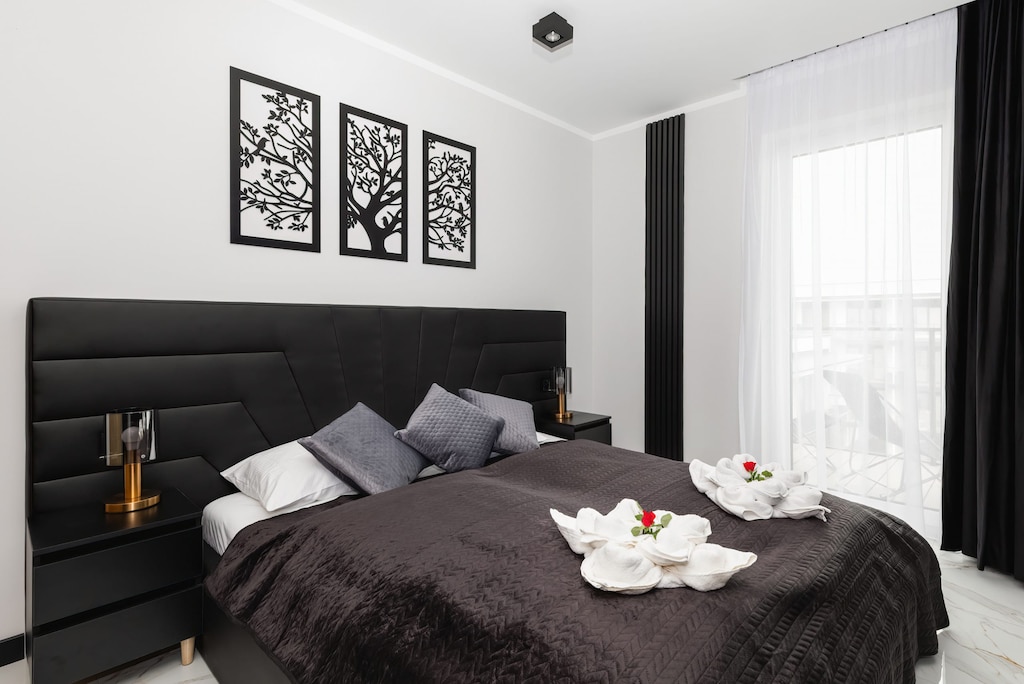 Stylish bedroom with a double bed and access to balcony.