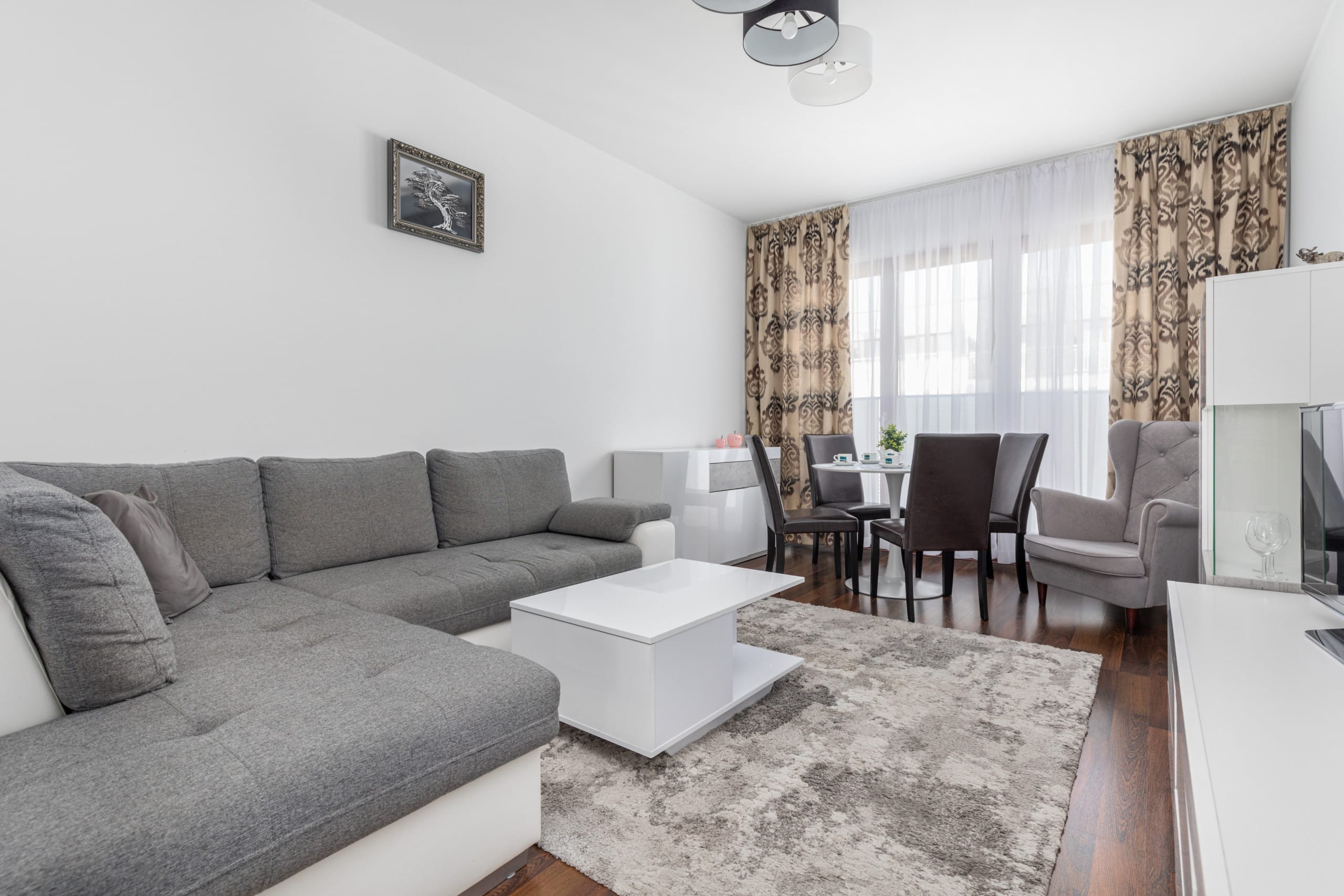 Spacious living room with a large sofa, coffee table, and a bright, modern design.
