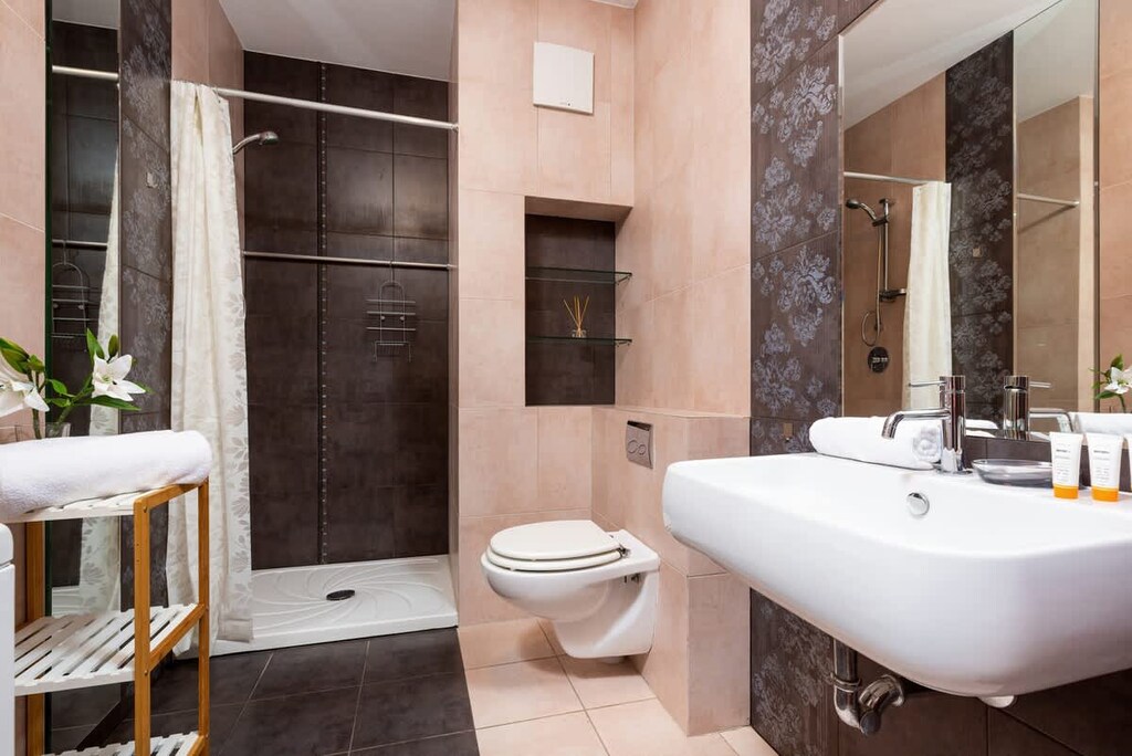 Bathroom with washing machine and towels. 