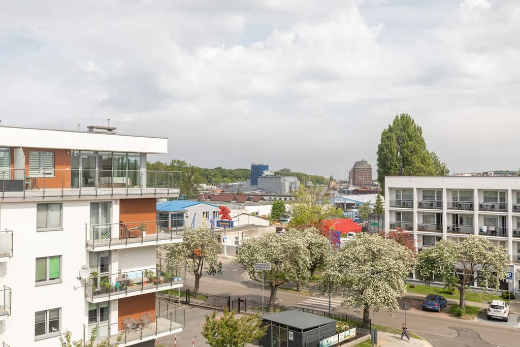 A scenic view of nearby residential buildings and green areas from a balcony or window.
