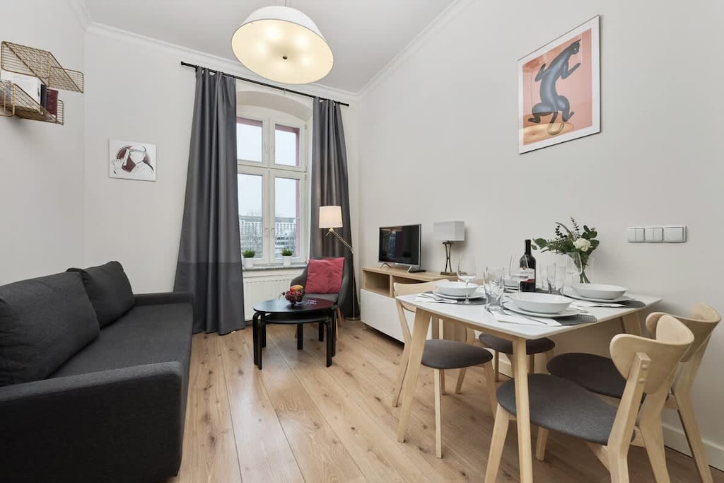 The living area features a sleek coffee table and a flat-screen television.