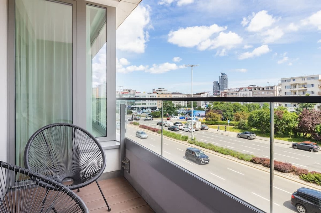 The balcony's stylish design complements the apartment's decor. 
