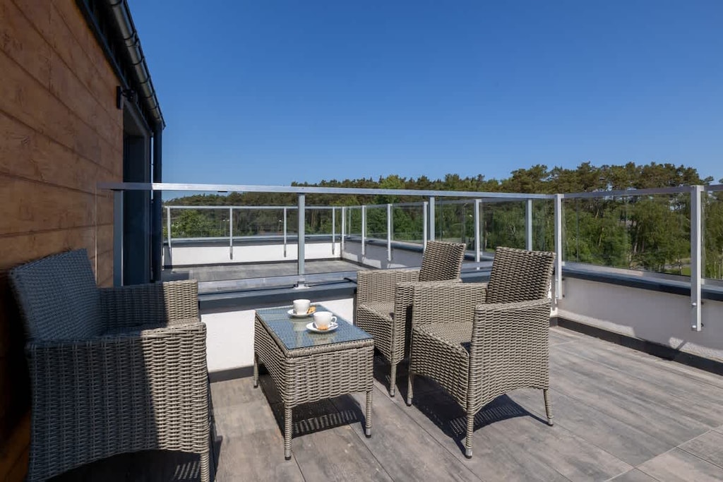 The terrace's stylish design complements the apartment's decor. 