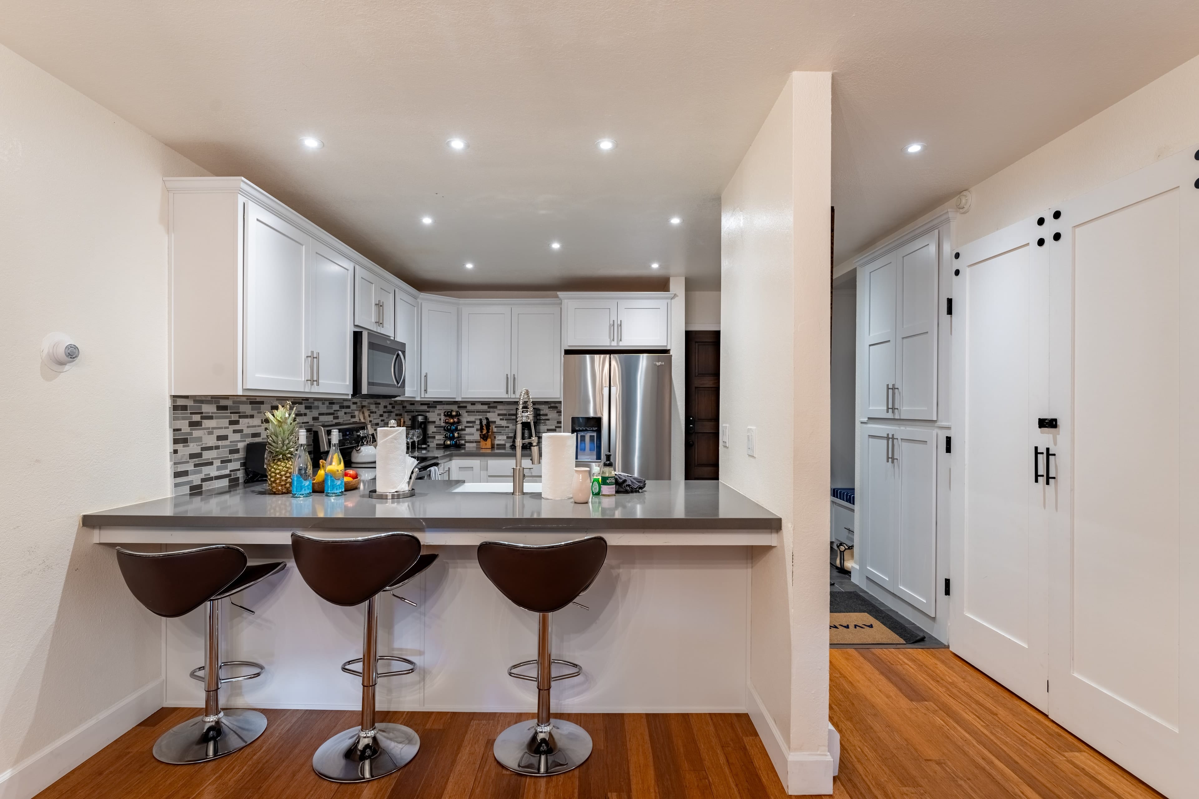 Sleek kitchen with barstool seats. Sleek kitchen with barstool seats.