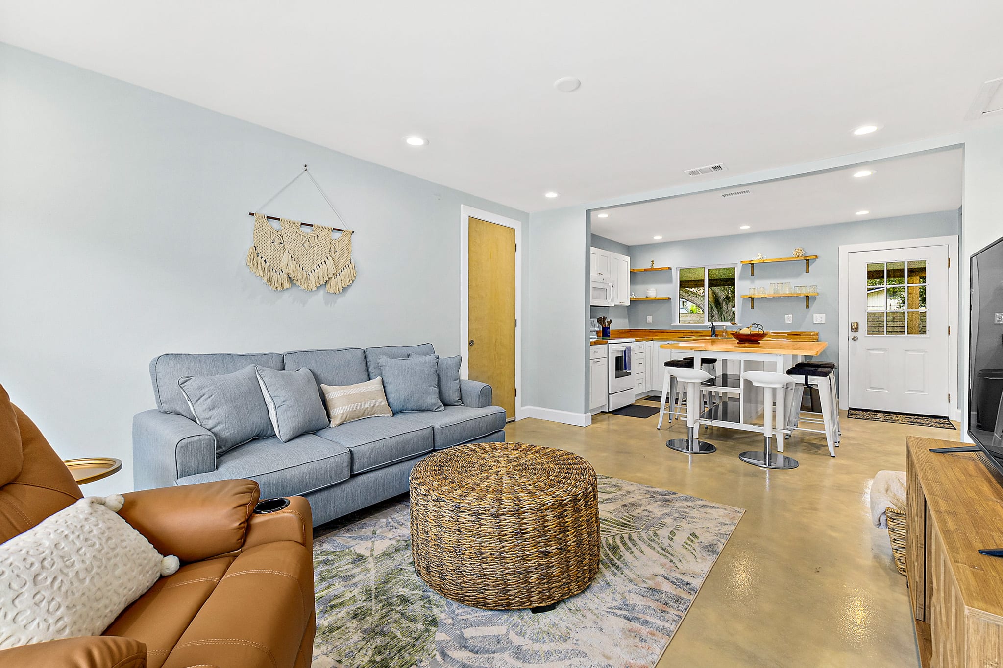 Relax on the recliner or sprawled out on the sofa in the bright living area