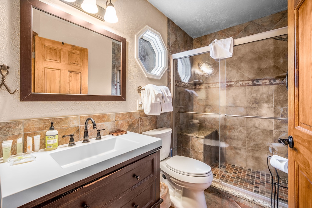 Master bathroom, walk in shower with 4" step, and stone bench.