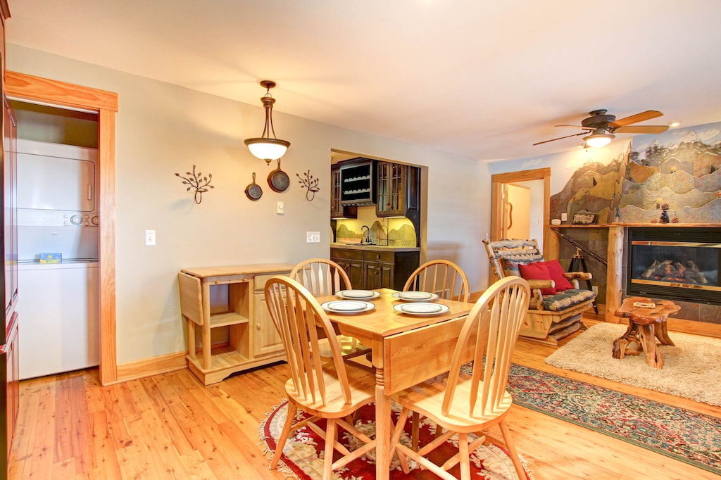 Open concept living/dining space, dining table with seating for four guests, newly updated electric fireplace.