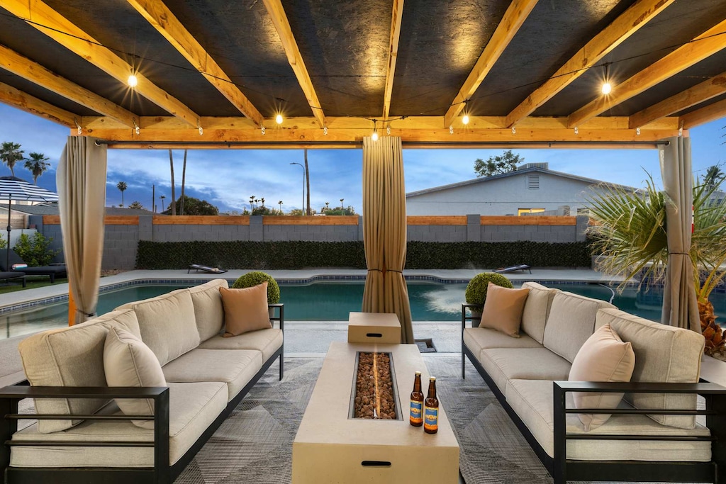 Enjoy the outdoor seating area with a firepit, perfect for relaxing by the pool.