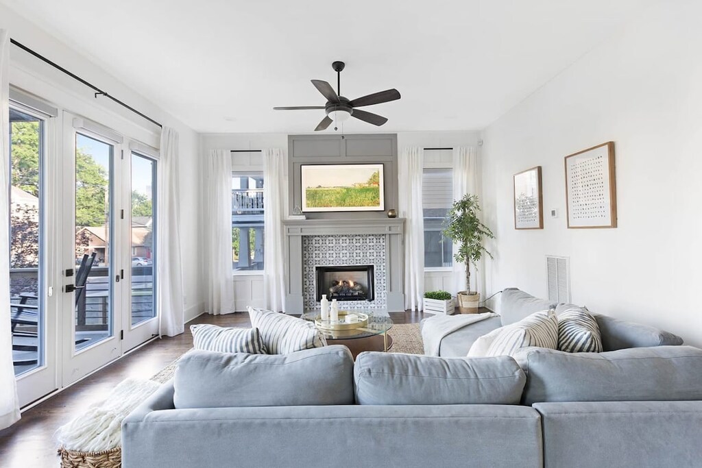 
The large front doors flood the cozy living room with natural light, creating a warm and inviting atmosphere.