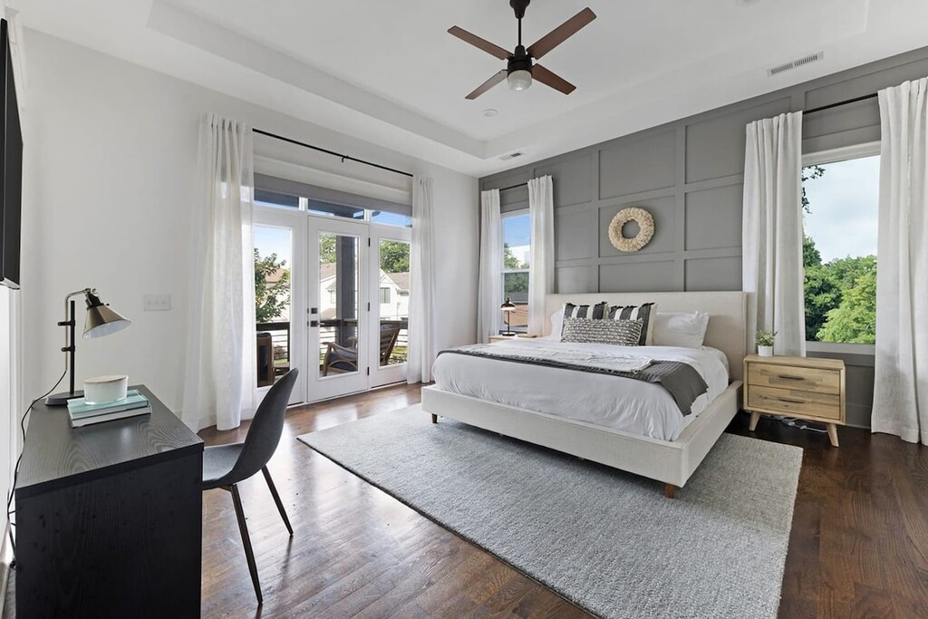 The second-floor master bedroom, featuring a king bed, offers an airy escape with plenty of space and natural light, creating a peaceful retreat.