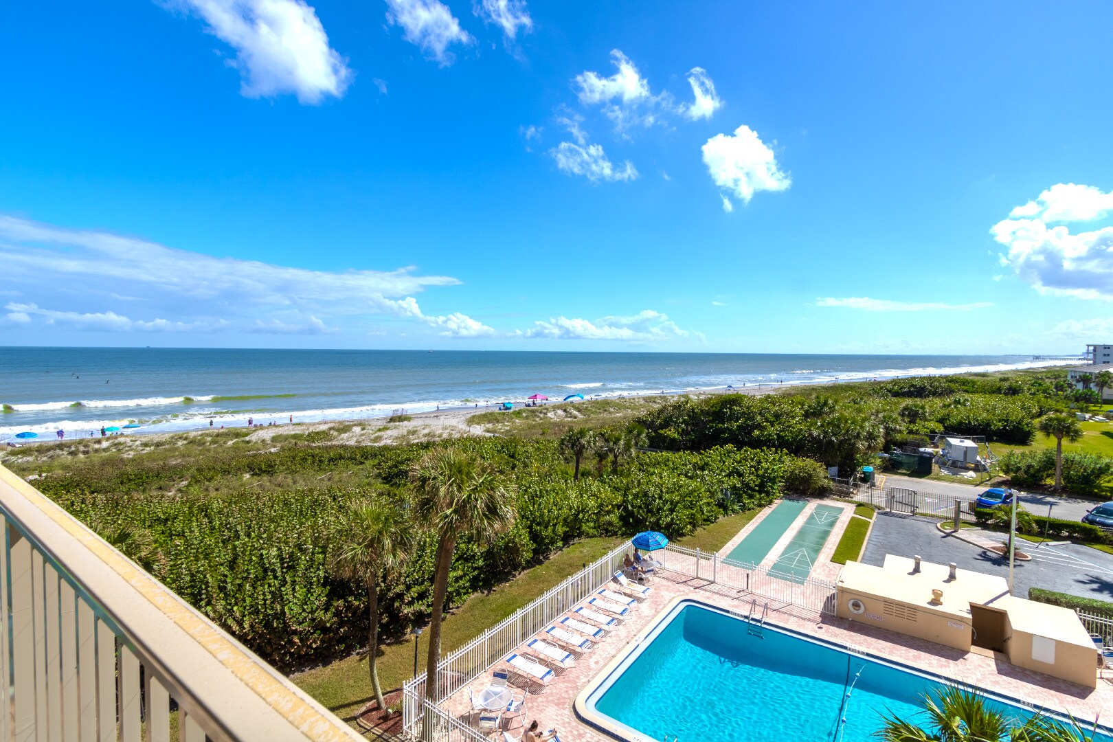 View of pool and beach from balcony