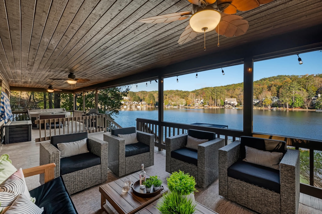 Bask in the beauty of the lake from the outdoor patio, featuring cozy seating and two hammock chairs perfect for peaceful moments.